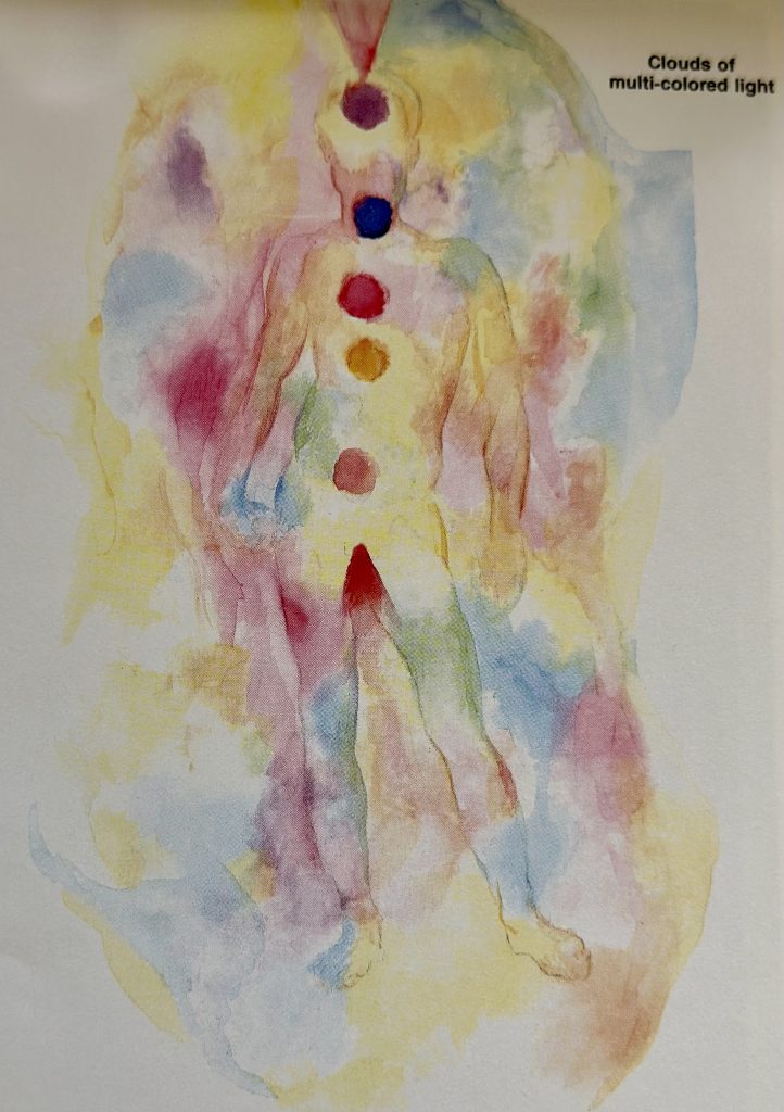 A scenic coastal road winding along rocky cliffs with a stunning ocean view under a partly cloudy sky.